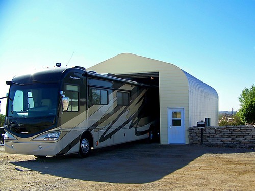 An RV halfway parked into a garage