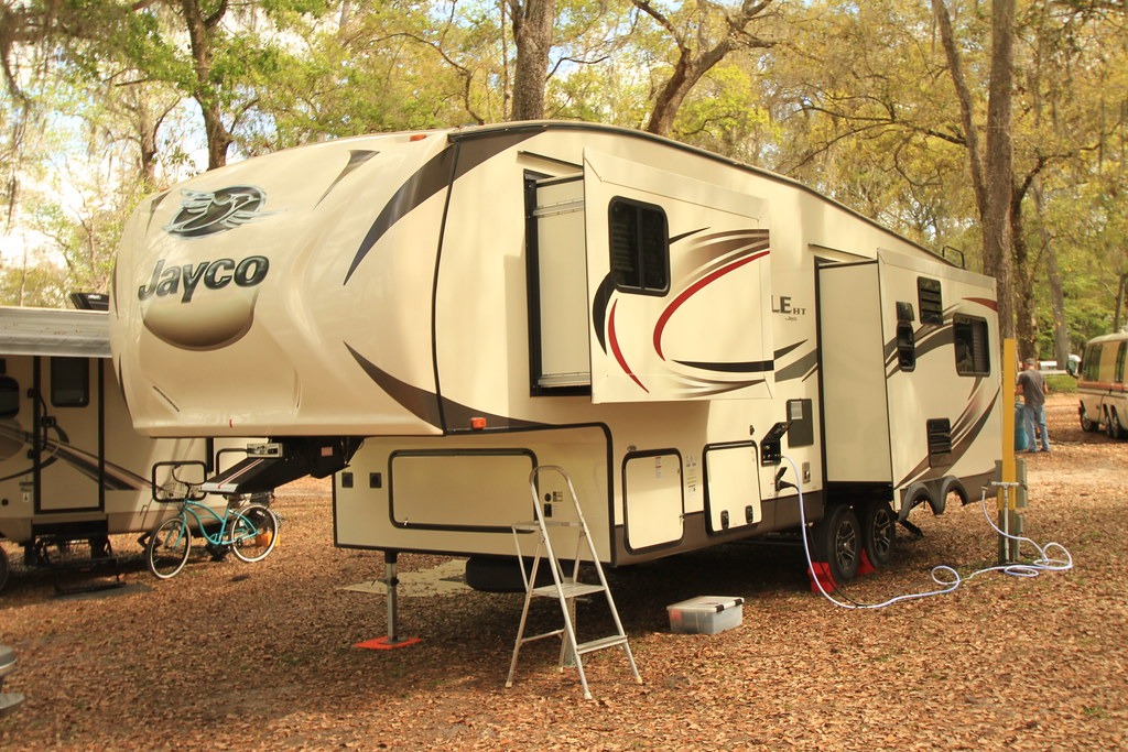 A Jayco Eagle HT 5th wheel rv camper parked in a campground in the fall