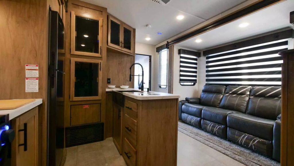 Interior view showcasing the ktichen and living area of the 2023 Forest River Vengeance Rogue Fifth Wheel RV